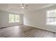 Spacious bedroom featuring a tray ceiling, ceiling fan, and two windows letting in natural light at 4959 Abbotts Glen Nw Trl, Acworth, GA 30101