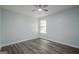 Light-filled bedroom featuring a ceiling fan, neutral paint, and stylish wood-look flooring at 4959 Abbotts Glen Nw Trl, Acworth, GA 30101