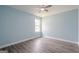 Bright bedroom with blue walls, wood-look floors, and a window letting in natural light at 4959 Abbotts Glen Nw Trl, Acworth, GA 30101
