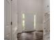 Bright entryway featuring a staircase with white railing and dark hardwood floors throughout at 4959 Abbotts Glen Nw Trl, Acworth, GA 30101