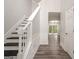 Bright entryway featuring a staircase with white railing and dark hardwood floors throughout at 4959 Abbotts Glen Nw Trl, Acworth, GA 30101