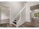 Bright entryway featuring a staircase with white railing and dark hardwood floors throughout at 4959 Abbotts Glen Nw Trl, Acworth, GA 30101