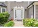 Inviting front entryway with white door and sidelights surrounded by manicured landscaping at 4959 Abbotts Glen Nw Trl, Acworth, GA 30101