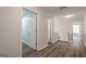 Bright hallway featuring modern flooring and neutral walls leading to multiple rooms at 4959 Abbotts Glen Nw Trl, Acworth, GA 30101