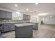 Open concept kitchen with grey cabinets, granite countertops, mosaic backsplash, and stainless steel sink at 4959 Abbotts Glen Nw Trl, Acworth, GA 30101