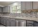 Modern kitchen with stainless steel appliances, subway tile backsplash and granite countertops at 4959 Abbotts Glen Nw Trl, Acworth, GA 30101