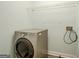 Functional laundry room with a silver front-load washing machine and wire shelving for storage at 4959 Abbotts Glen Nw Trl, Acworth, GA 30101
