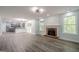 Bright, open-concept room with a fireplace and view into the kitchen at 4959 Abbotts Glen Nw Trl, Acworth, GA 30101