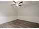 Empty room with wainscotting, crown molding, wood-look floors and a modern ceiling fan with light at 4959 Abbotts Glen Nw Trl, Acworth, GA 30101