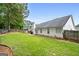 Well-maintained backyard with green grass, patio area, and a view of the home's exterior at 192 Sandhurst Ct, Suwanee, GA 30024