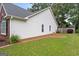 Well-maintained backyard with brick edging, lush grass, and mature landscaping at 192 Sandhurst Ct, Suwanee, GA 30024