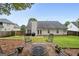 Inviting backyard featuring a brick patio with a fire pit, chairs, and lush green lawn at 192 Sandhurst Ct, Suwanee, GA 30024