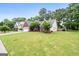 Beautiful red brick home featuring a lush lawn and mature trees in a desirable neighborhood at 192 Sandhurst Ct, Suwanee, GA 30024