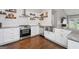 Well-equipped kitchen featuring a stainless steel sink, modern appliances, and stylish backsplash at 192 Sandhurst Ct, Suwanee, GA 30024