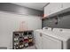 Convenient laundry area with modern appliances, storage cabinets, and shelving units at 192 Sandhurst Ct, Suwanee, GA 30024