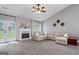 Inviting living room features a cozy fireplace and access to the backyard through french doors at 192 Sandhurst Ct, Suwanee, GA 30024