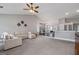 Spacious living room with a ceiling fan, fireplace, and lots of natural light at 192 Sandhurst Ct, Suwanee, GA 30024