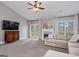 Comfortable living room with a fireplace, picture windows, and natural light at 192 Sandhurst Ct, Suwanee, GA 30024