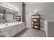 Bright main bathroom features double vanity, large mirror, and separate shower and tub at 192 Sandhurst Ct, Suwanee, GA 30024