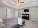 Relaxing main bedroom features tray ceiling, TV, and ensuite bathroom access at 192 Sandhurst Ct, Suwanee, GA 30024