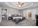Large main bedroom features a tray ceiling and adjoins the ensuite bathroom and a storage room at 192 Sandhurst Ct, Suwanee, GA 30024