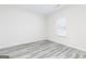 Well-lit bedroom with modern grey flooring and a large window for natural light at 3373 Arabian Farm Dr, Dacula, GA 30019