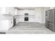 Bright kitchen showcases white cabinetry, stainless steel appliances, subway tile backsplash, and durable gray floors at 3373 Arabian Farm Dr, Dacula, GA 30019