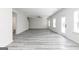 Expansive living area with grey flooring, ceiling fan, and multiple windows for natural light at 3373 Arabian Farm Dr, Dacula, GA 30019