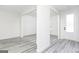 Bright, open-concept living space with grey flooring and fresh white paint throughout at 3373 Arabian Farm Dr, Dacula, GA 30019