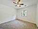 A bright bedroom featuring neutral carpet and a window with a natural view at 10173 Brass Ring Rd, Jonesboro, GA 30238