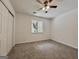 Bright bedroom with a window view, ceiling fan, closet and neutral carpet at 10173 Brass Ring Rd, Jonesboro, GA 30238