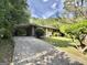 Home's driveway features a convenient carport and lush landscaping at 10173 Brass Ring Rd, Jonesboro, GA 30238
