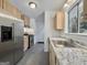 Well-lit kitchen featuring stainless steel appliances, granite countertops and light wood cabinets at 10173 Brass Ring Rd, Jonesboro, GA 30238