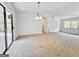 Bright living room with carpet, featuring a sliding glass door and large windows at 10173 Brass Ring Rd, Jonesboro, GA 30238