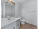 Bright bathroom with modern vanity, large mirror, and light wood floors at 2000 Stacia Dr, Covington, GA 30016
