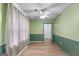 This bedroom features light green walls, a ceiling fan, and hardwood floors at 2000 Stacia Dr, Covington, GA 30016