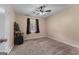 Comfortable bedroom featuring plush carpeting, a ceiling fan, and natural light from the window at 2000 Stacia Dr, Covington, GA 30016