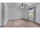 A simple bedroom with plush carpet, neutral walls, and a ceiling fan at 2000 Stacia Dr, Covington, GA 30016