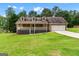 Charming home with a front porch, dormer windows, and well-maintained lawn and landscaping at 2000 Stacia Dr, Covington, GA 30016