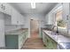 Charming kitchen featuring light green cabinets, granite counters, and a bright window at 2000 Stacia Dr, Covington, GA 30016