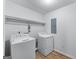 This practical laundry room features a washer, dryer, and easy-to-clean tile floors at 2000 Stacia Dr, Covington, GA 30016