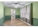 This living room offers hardwood floors, green walls, and access to the kitchen at 2000 Stacia Dr, Covington, GA 30016