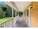 Spacious covered porch featuring wood-plank flooring and potted plants at 2000 Stacia Dr, Covington, GA 30016