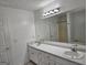 Bathroom featuring double sinks, a vanity, and a separate tub and shower at 10 Nicole Ct, Covington, GA 30016
