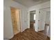 Hallway leading to bathroom and bedroom features wood flooring and white trim at 10 Nicole Ct, Covington, GA 30016