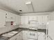 Bright kitchen with white cabinets, range, and granite countertops at 10 Nicole Ct, Covington, GA 30016