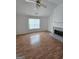 Bright living room with hardwood floors, stone fireplace, and plenty of natural light at 10 Nicole Ct, Covington, GA 30016
