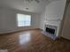 Open living room featuring fireplace, vaulted ceilings, and natural light from large window at 10 Nicole Ct, Covington, GA 30016