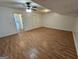 Spacious living room featuring wood floors, a ceiling fan, and white walls at 10 Nicole Ct, Covington, GA 30016
