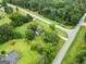 Aerial view of home and neighborhood with mature trees and landscaping at 615 Coan Dr, Locust Grove, GA 30248